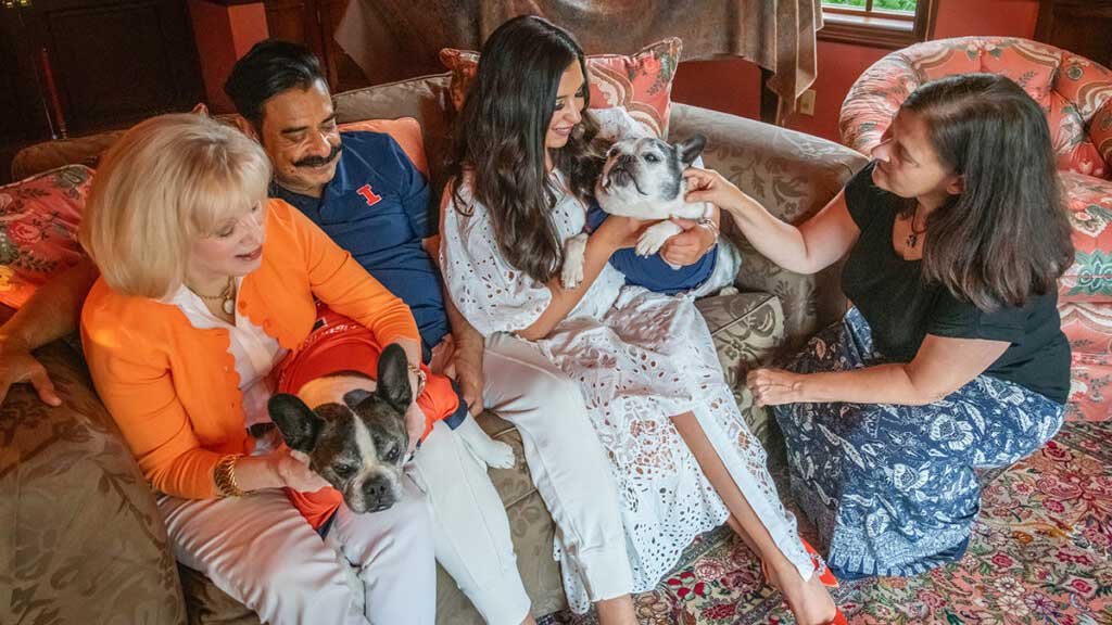 The Khan family – Ann and Shahid holding Louie, Shanna holding Shanelle – visits with Dr. Laura Garrett in their home.