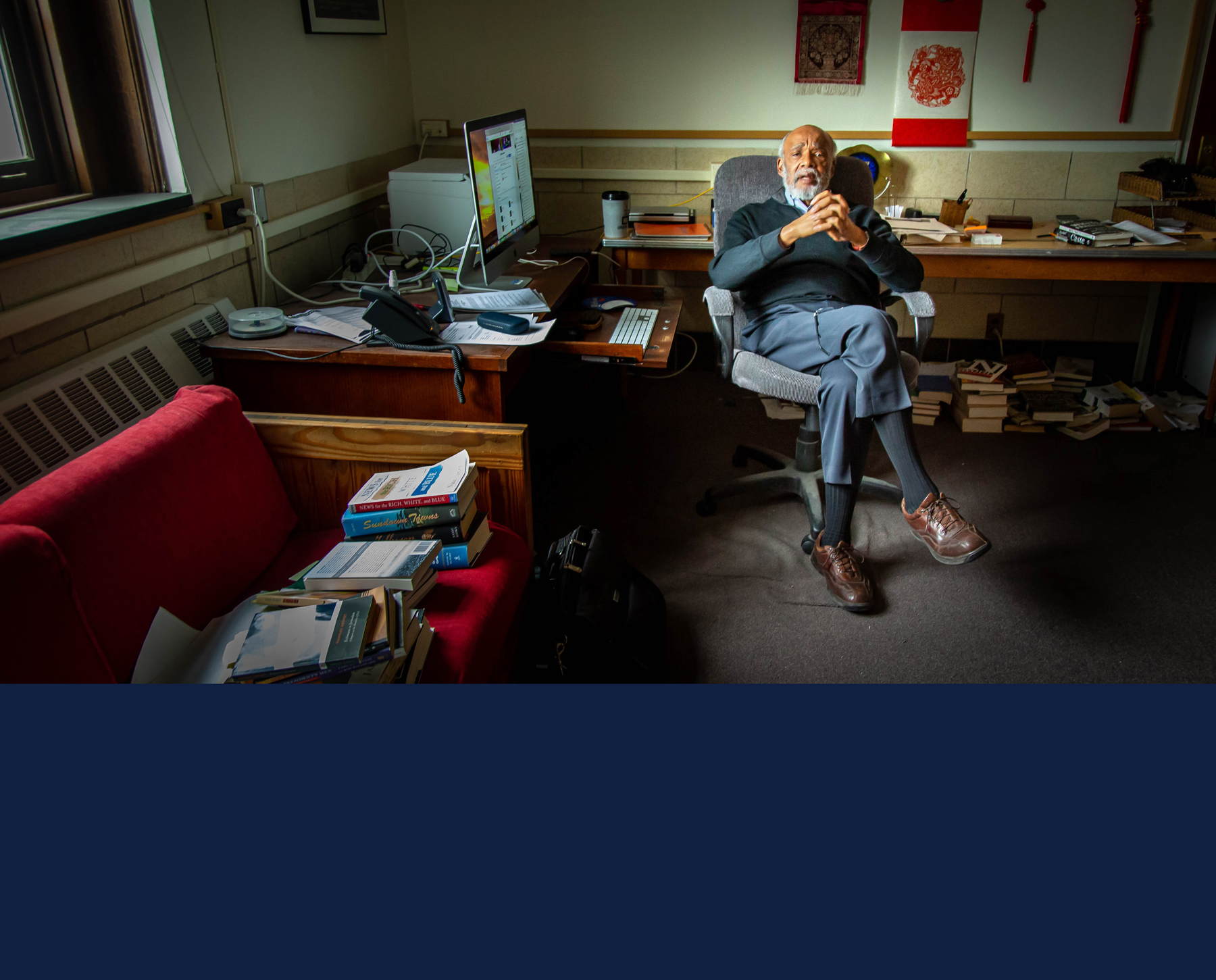 Professor Leon Dash sits in his office