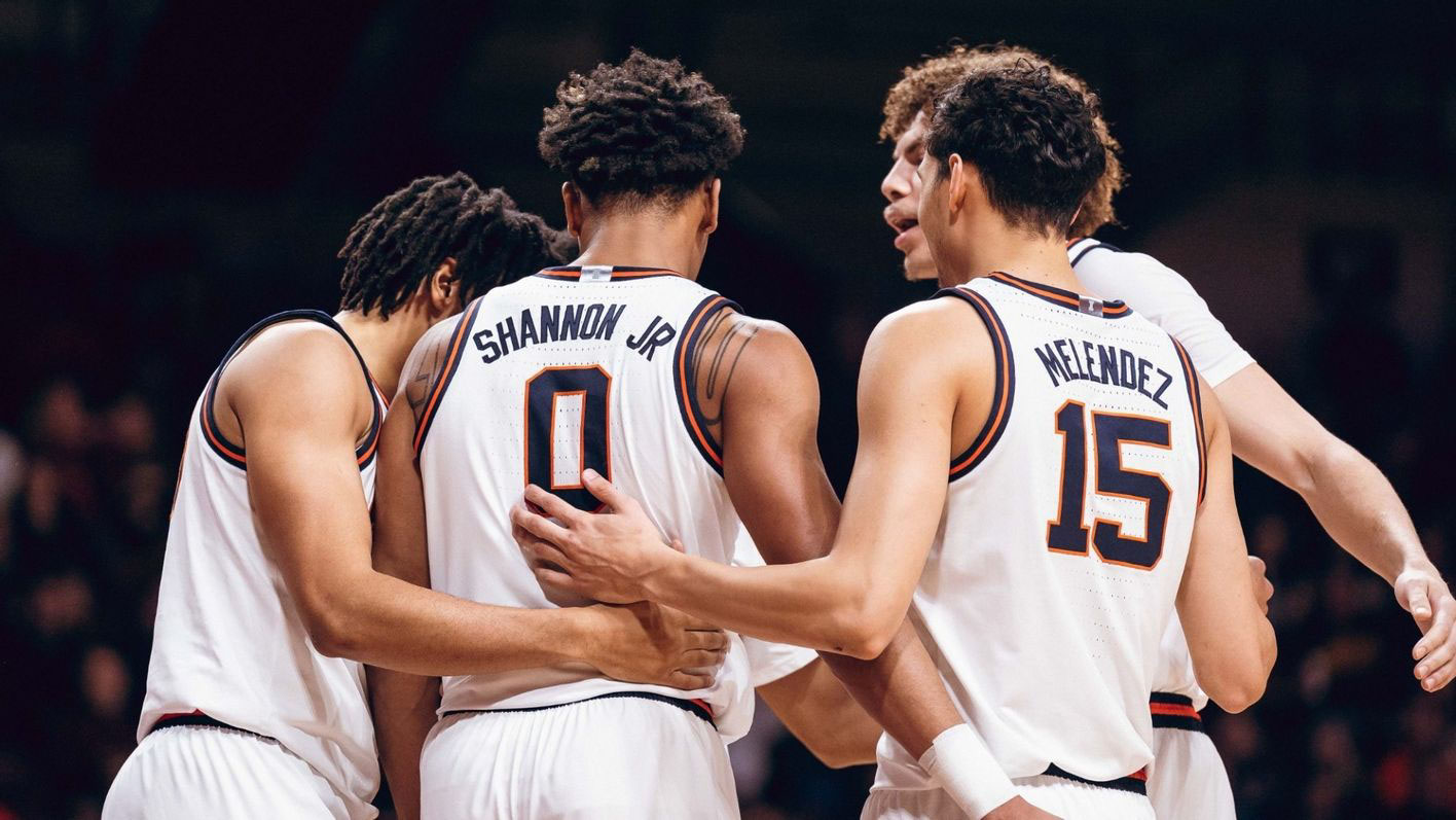 Illini basketball players huddle on court during a break in the action on Monday