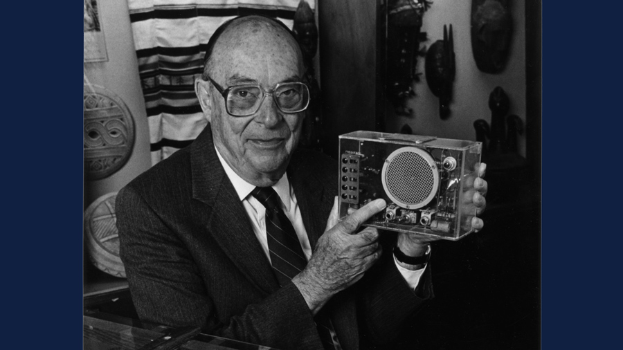 U of I professor John Bardeen holding an early example of his transistor