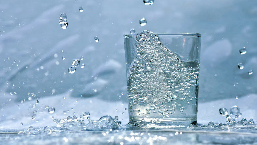 clean clear drinking water splashes into a glass. stock photo via Storyblocks