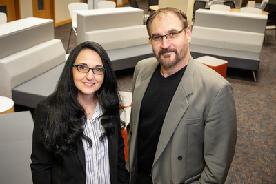 Psychology professors Sanda Dolcos, left, and Florin Dolcos stand in an empty seating area in the Beckman Institute.