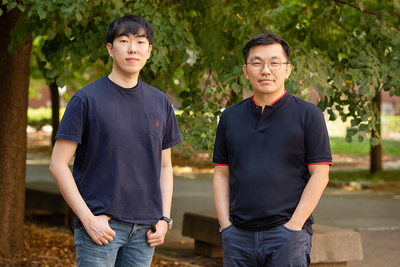 Byungsoo Kim, left, and professor Hyunjoon Kong stand outdoors, socially distanced.