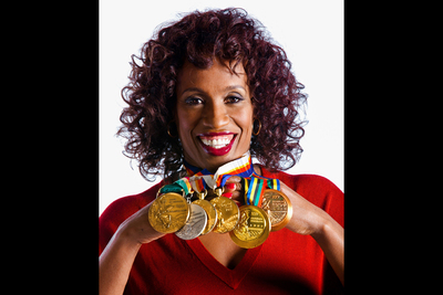 Jackie Joyner-Kersee displaying Olympic medals