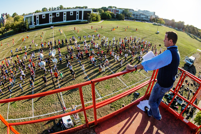 Band director Barry Houser supervises the Marching Illini last fall from a rented scissor lift overlooking the field north of Krannert Art Museum, one of the bands two unofficial campus practice locations.