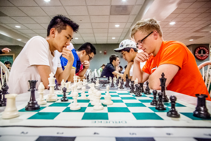 Chess Club members Bo Schmidt, right, a senior in physics, plays against Benson Wang, a freshman in electrical and computer engineering, in the food court of the Illini Union.