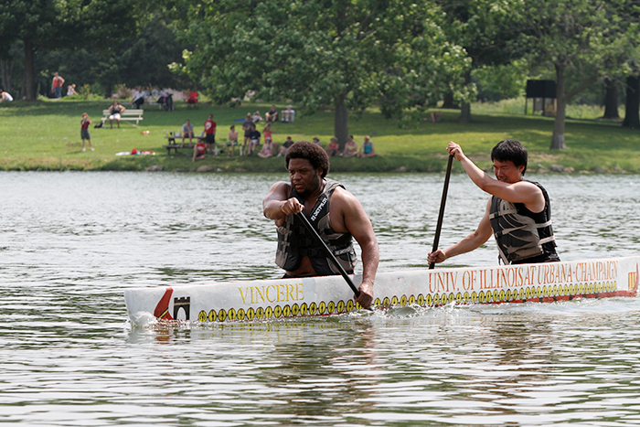 Boneyard Yacht Club members and U. of I. students Robert Butler, left, and Min Yin power their vessel, christened Vincere, during the races at Homer Lake on June 22.