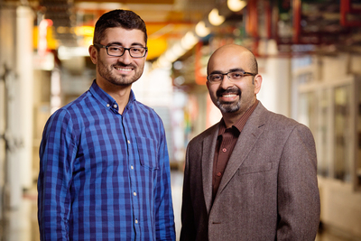 A robot under development at the University of Illinois automates the labor-intensive process of crop phenotyping, enabling scientists to scan crops and match genetic data with the highest-yielding plants. Agricultural and biological engineering professor Girish Chowdhary, right, is working on the $3.1 million project, along with postdoctoral researcher Erkan Kayacan.