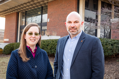 Researchers Jennifer Delaney and Bradley Hemenway standing outside a building on the U. of I.'s Urbana campus