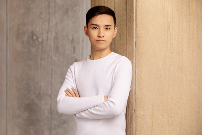 Portrait of Fan Xuan Chen. He is standing with arms crossed.