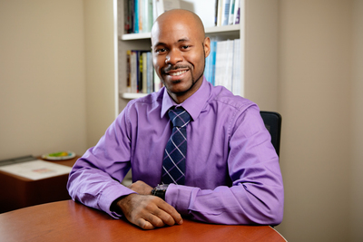 Photo of social work professor Ryan Wade in his office at the School of Social Work