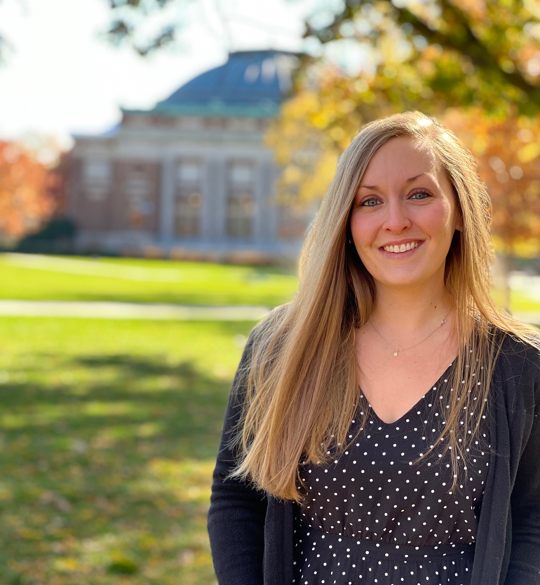 Haley Skymba smiles for a photograph against the backdrop of Foellinger Auditorium.