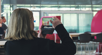 Dr. Patricia Lalor, a senior investigator in the Centre for Liver and Gastroenterology Research at the University of Birmingham, takes a picture on her phone during a May 15 tour of the Siebel Center.