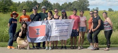 Yun Shi, the director for International Education pictured on the far left; Kimberly Yau, the associate director for training and programming in International Student and Scholar Services pictured on the far right; and Bree Singleton, and international student advisor in Illinois Education pictured sixth from the left; pose for a photo with several ISSS and IE students during their July 29 visit to Clinton Lake State Recreation Area.