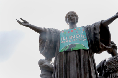 Alma Mater is seen here wearing a banner that reads "Illinois Abroad Day."