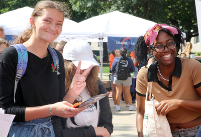 (From left to right) Janey Winiecki, Nikki Miziniak, and Arylssia Kelly stand in front of the Illinois Abroad and Global Exchange tent during last year’s Illinois Abroad Day on Sept. 7, 2022.