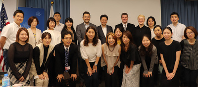 Speakers and audience members attending a July 12 Partnership Dialogue Series hosted by Kyushu University take a photo together following the event.