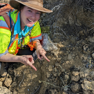 Sara Johnson points to a federally endangered Zapata bladderpod specimen growing in the field