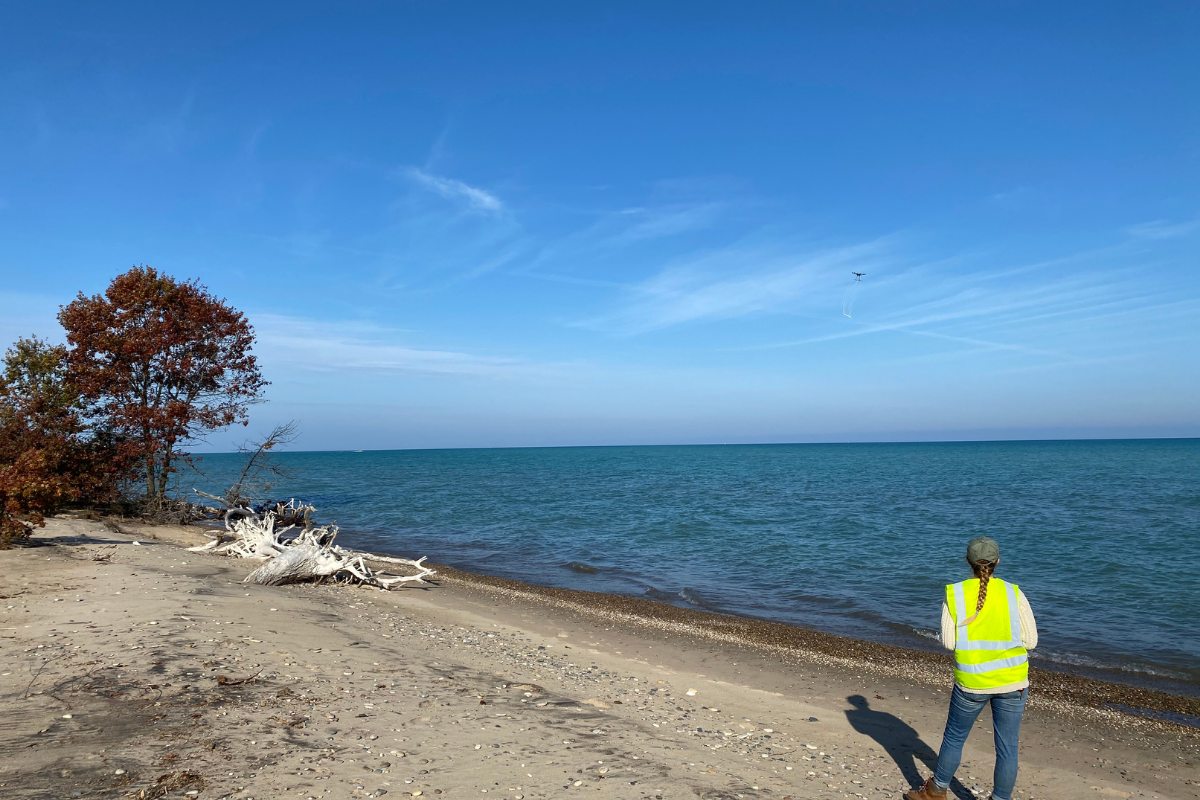 ISGS research technician Katie Braun flies a drone over Lake Michigan, collecting data by mapping magnetic materials both above and buried beneath the surface. 
