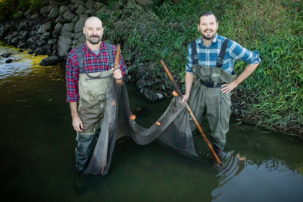 Chris Taylor and Eric Larson standing in a stream