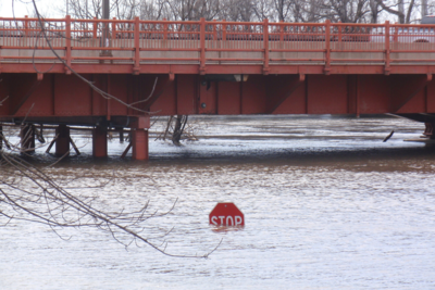 floodwaters covering most of a traffic sign