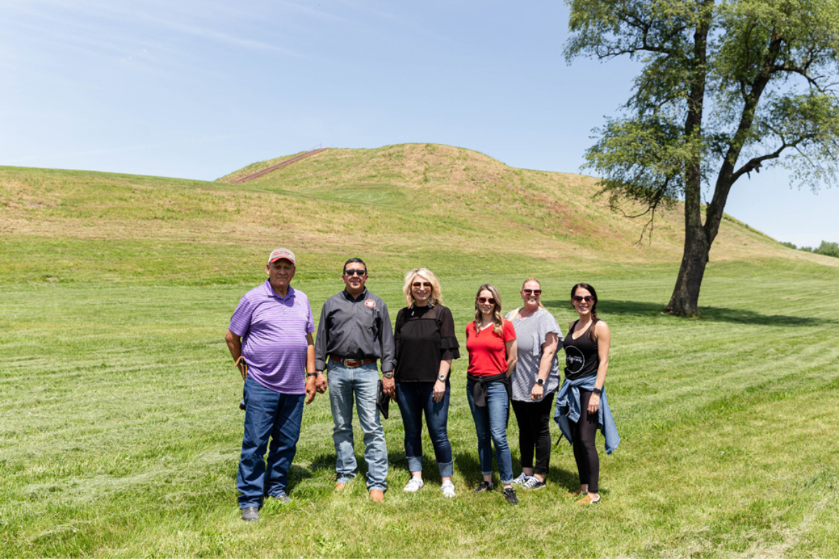 The Peoria Business Committee stands in front of Monks Mound, L to R: Treasurer Hank Downum, Chief Craig Harper, Second Councilman Kara North, Third Councilman Isabella Clifford, Second Chief Rosanna Dobbs, and Secretary Tonya Mathews