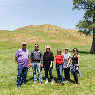 The Peoria Business Committee stands in front of Monks Mound, L to R: Treasurer Hank Downum, Chief Craig Harper, Second Councilman Kara North, Third Councilman Isabella Clifford, Second Chief Rosanna Dobbs, and Secretary Tonya Mathews
