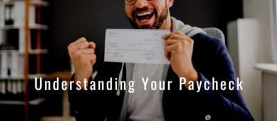 Man smiling while holding paycheck. White text reads "Understanding Your Paycheck"