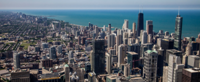 tall buildings in downtown Chicago in the foreground, with Lake Michigan in the background