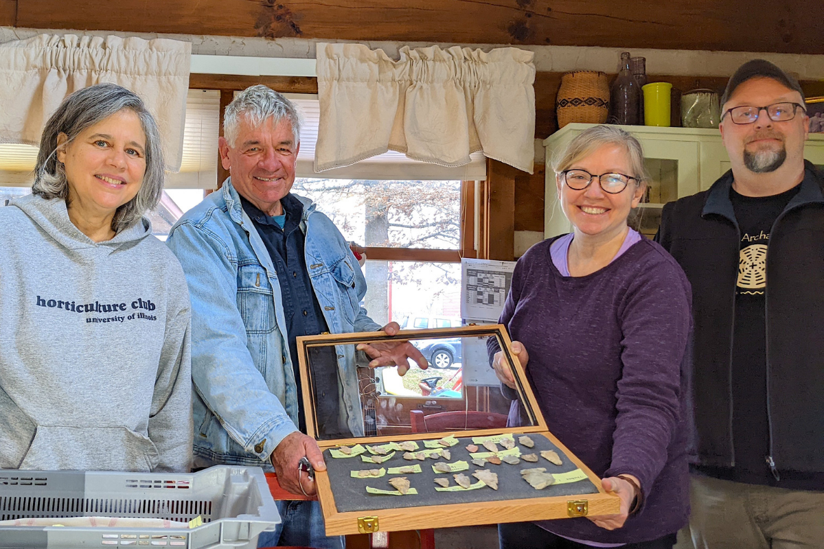 (Left to Right) Prairie Fruits Farm & Creamery founders Leslie Cooperband, Wes Jarrell, and ISAS staff Madeline Evans and Mike Smith holding artifacts. 