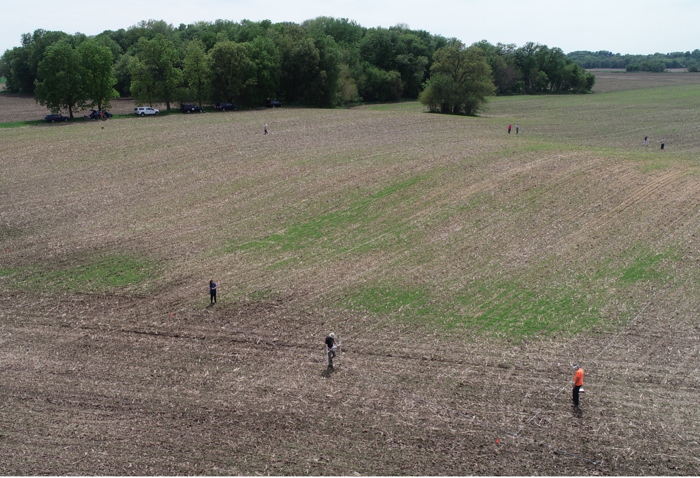Aerial photo taken with a drone showing ISAS crews conducting magnetic gradiometer survey in two grid squares flanking the ridge. Photo credit: John Lambert.