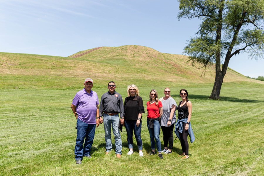 The Peoria Business Committee stands in front of Monks Mound, Left to Right: Treasurer Hank Downum, Chief Craig Harper, Second Councilman Kara North, Third Councilman Isabella Clifford, Second Chief Rosanna Dobbs, and Secretary Tonya Mathews