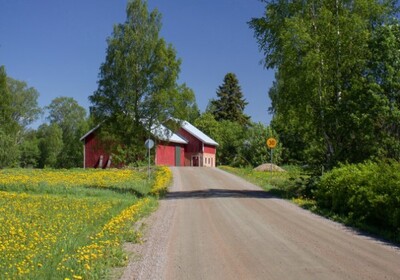 a barn and house on a rural road