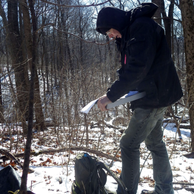 Kenton Geier holding a clipboard working in the field