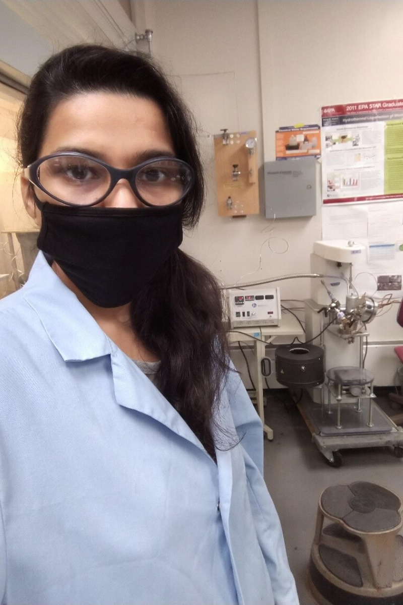 Postdoctoral researcher Kirtika Kohli wears the required cloth face covering and personal protective equipment while working in the lab at ISTC. 
