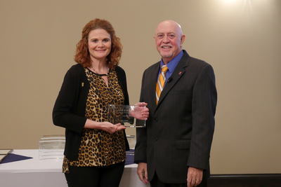 April Burgett and Mark Ryan with her award