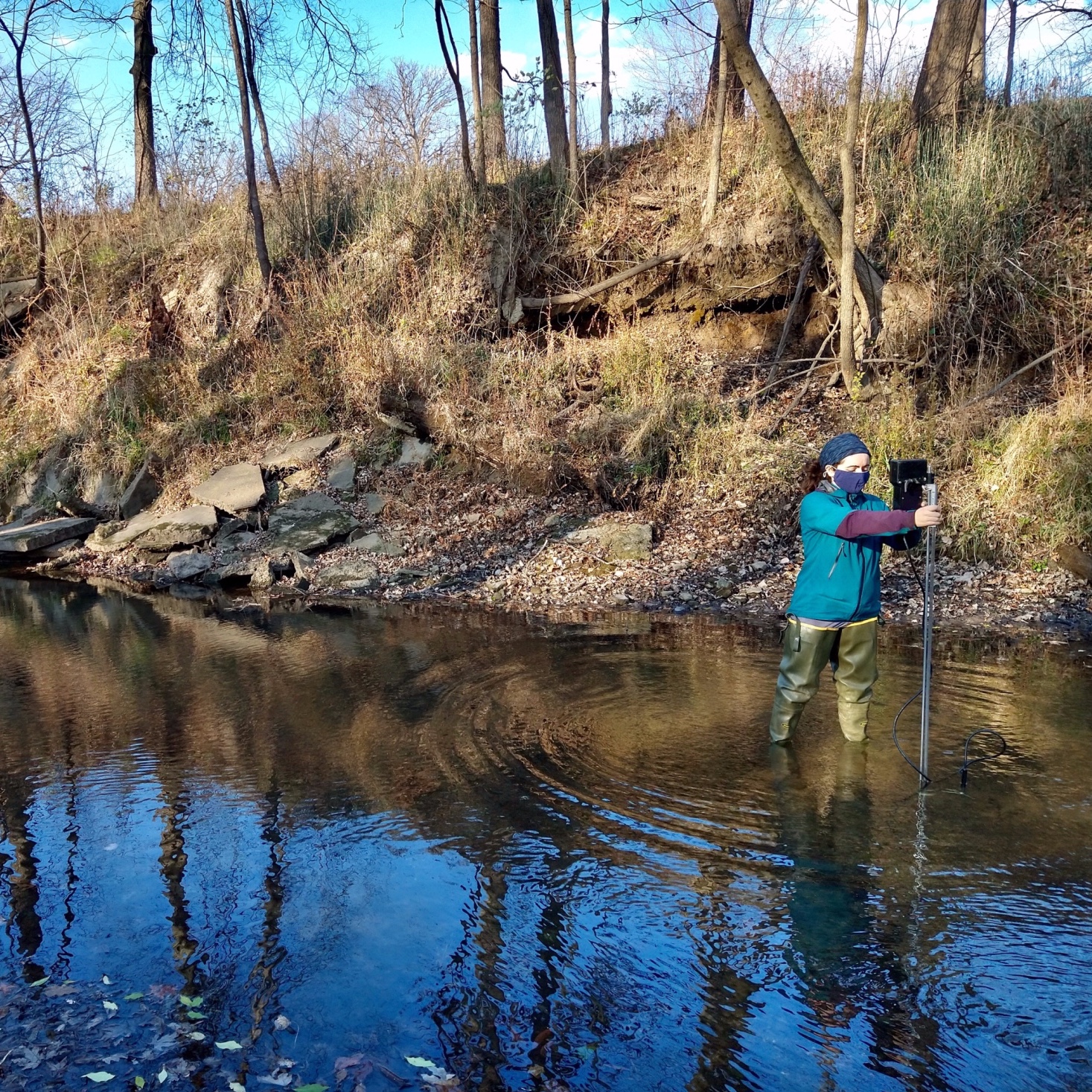 Margaret Golden setting up equipment in a river.