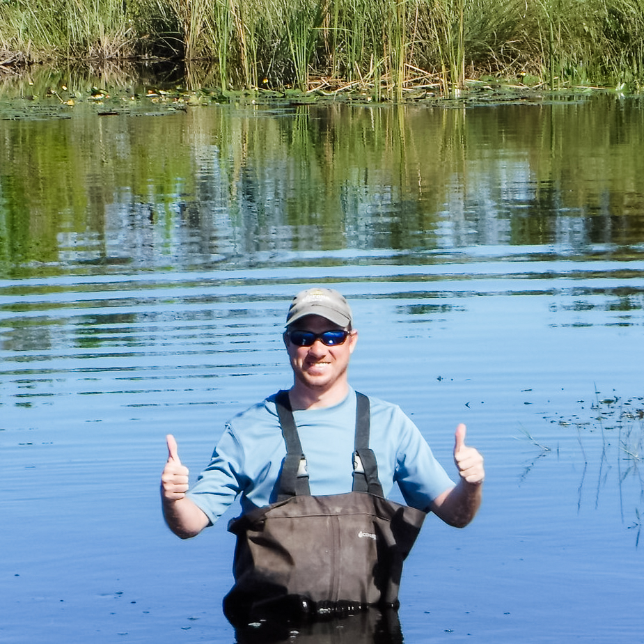 John Gatto standing in water in waders