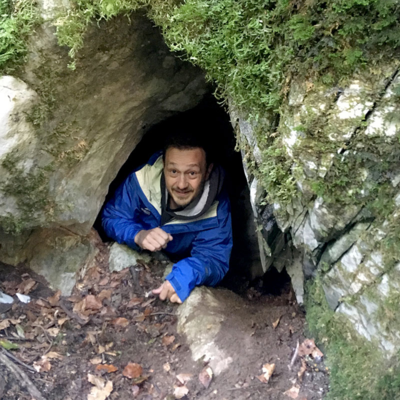 Max Allen emerging from a brown bear den in Slovenia.