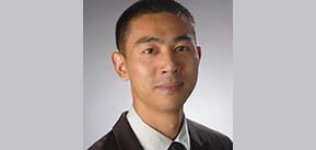 headshot of Professor Yang Wang in front of grey photodrop