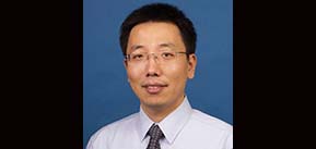 Headshot of Associate Professor Dong Wang on blue background.