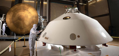 It displays the photo of the heat shield (left) and back shell (right) comprise the aeroshell for NASA's Mars 2020 mission.