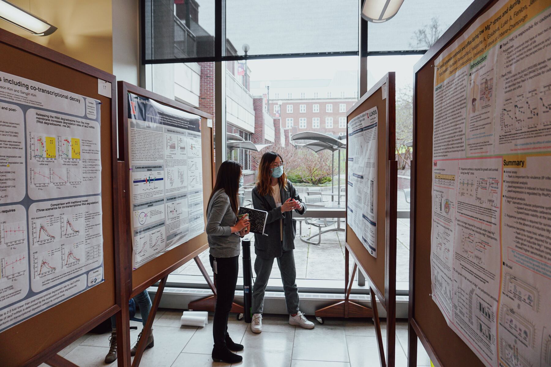 Two students at the poster session during the 2022 symposium