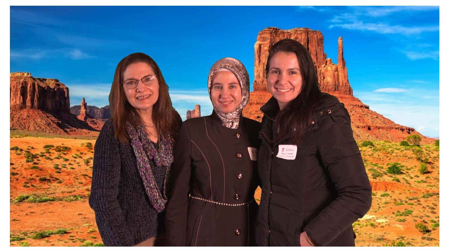 Donna Tonini, Eman Saadah and Raquel Castro Goebel posing in front of the desert backdrop
