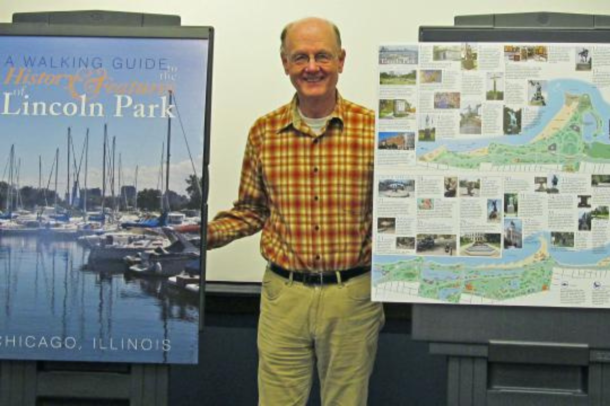 ISGS director Dick Berg stands with a poster of the Lincoln Park walking guide cover