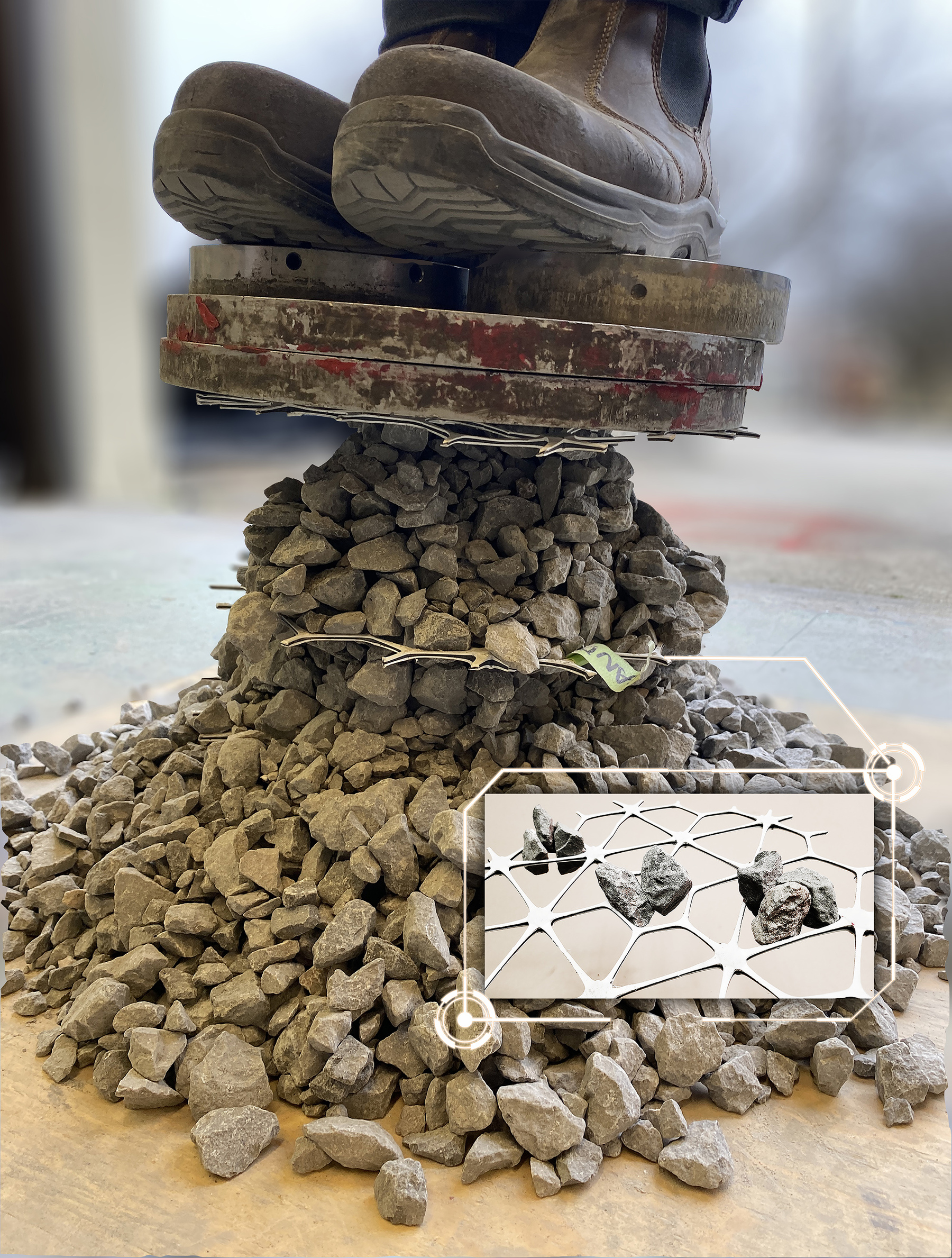 Two feet stand on top of a thin pile of loose rocks. A small layer of webbing can be seen in the pile.